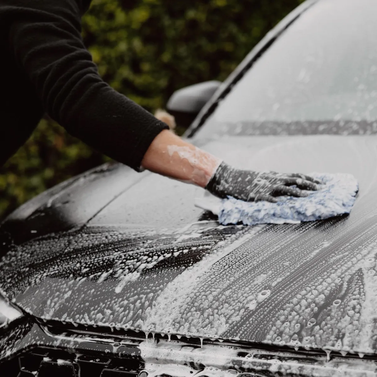 Mason washing car exterior, expert mobile car detailing in Queenstown