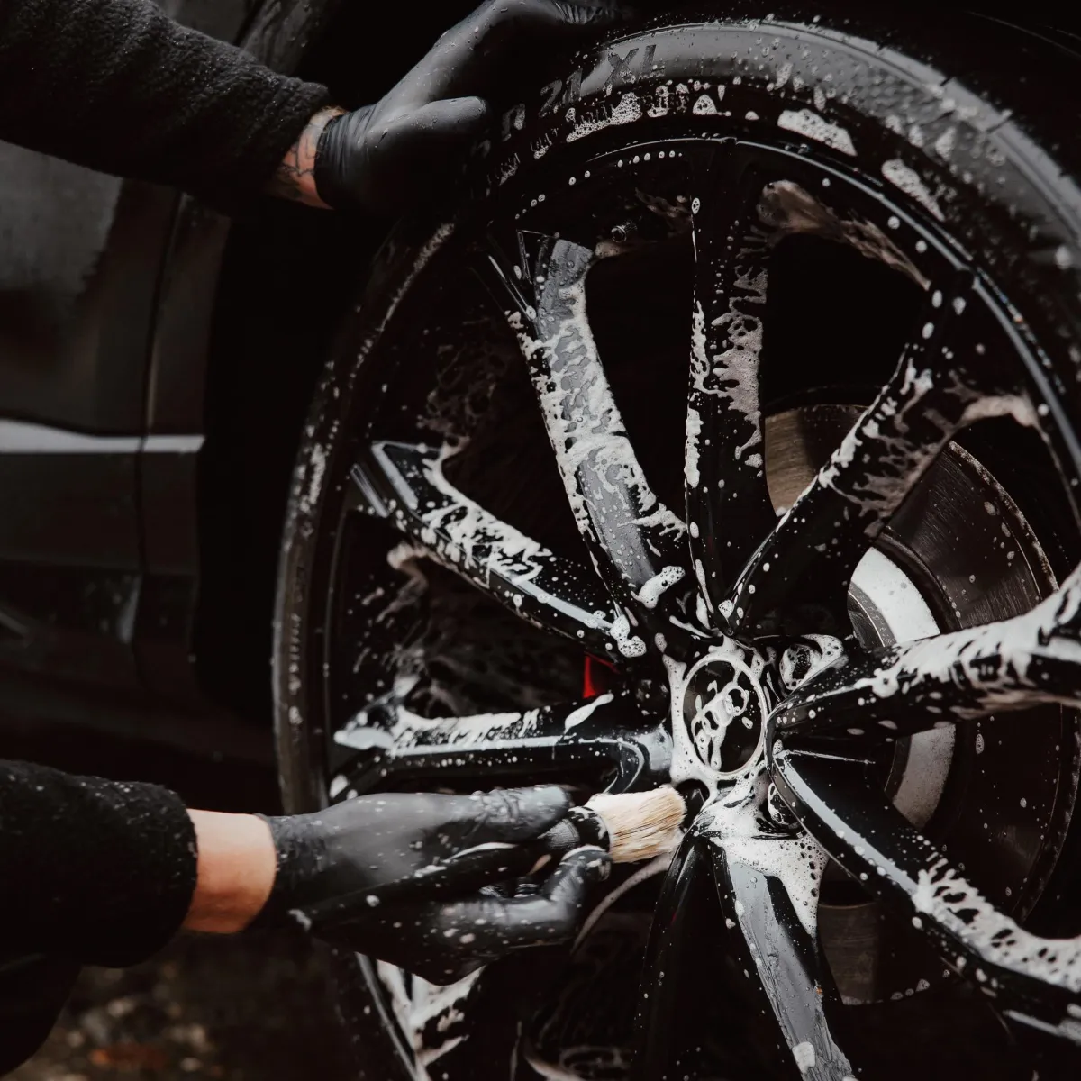 Mason detailing car wheel, expert mobile car detailing in Queenstown