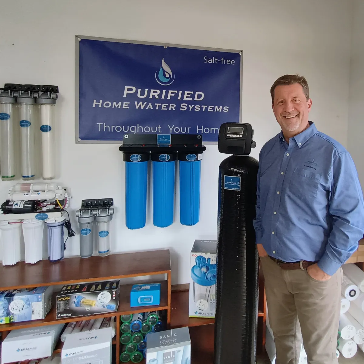 Chris standing next to a purificaion system