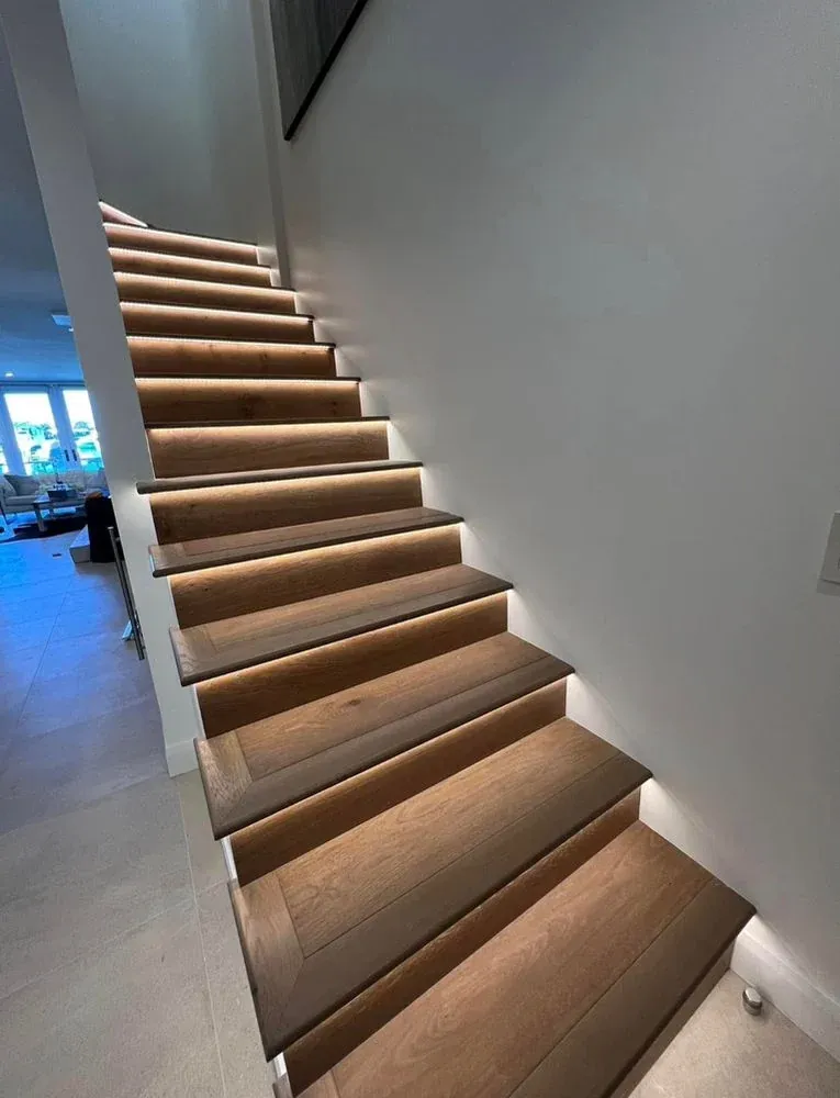 JCL residential flooring project showing wood-look floors and a staircase