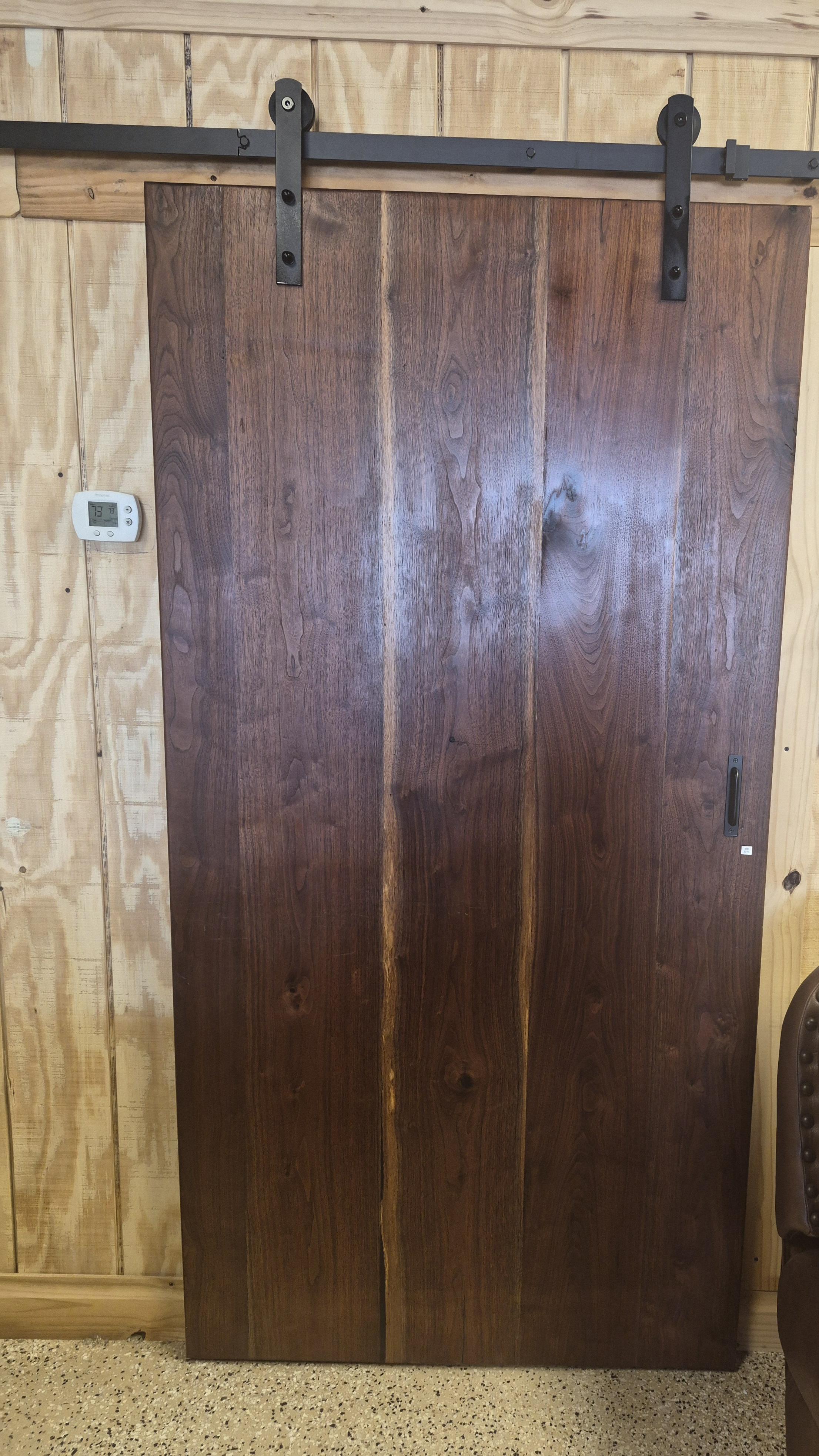 Solid wood entry doors, sliding barn doors, and handcrafted light fixtures at Piney Woods Custom Woodworks