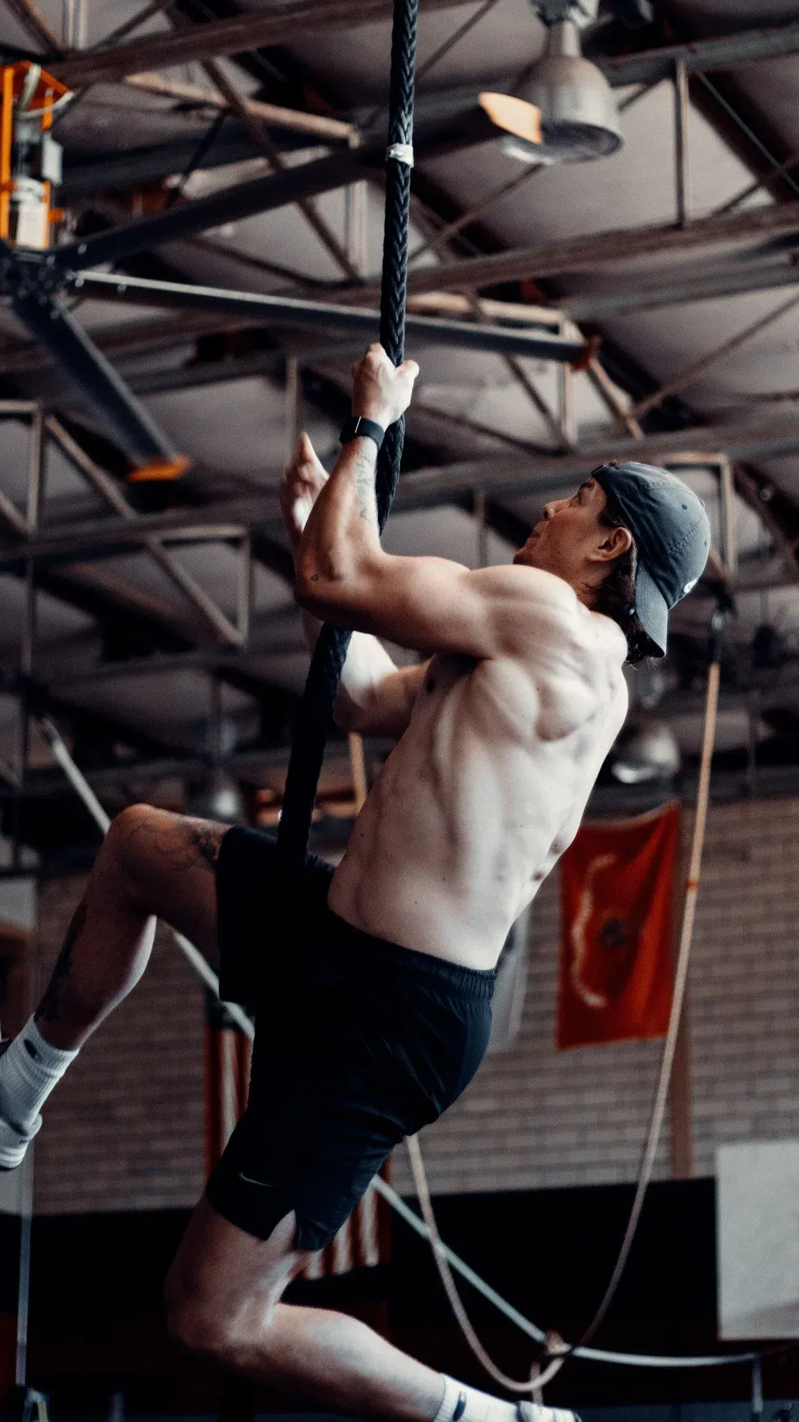 Athlete climbing a rope during a strength and conditioning session — performance training at Pinnacle in Lubbock