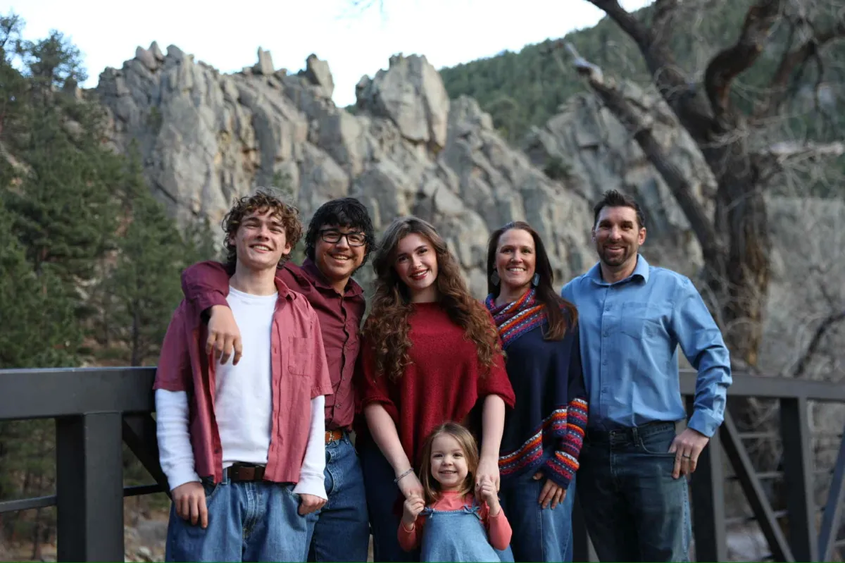 Mother holding newborn in soft natural light at home
