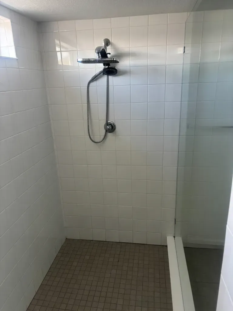  "Soap scum on Castle Pines shower grout — calcium stearate from hard water, removed with alkaline pre-treatment and high-pressure extraction"