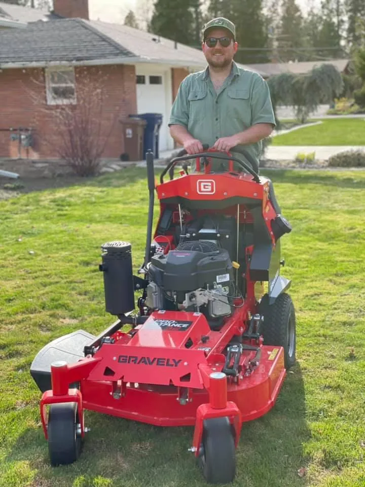 White Tail Lawn and Plow owner Jason Satcher mowing a clients lawn.