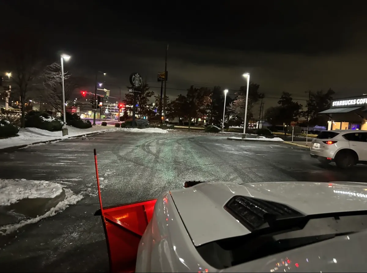 A perfectly snow fee parking lot plowed by White Tail Lawn and Plow.