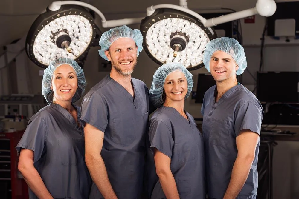 Four medical professionals in an operating room