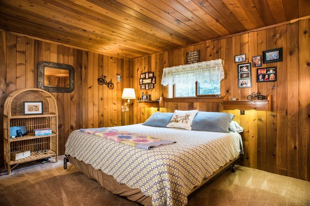 Log cabin bedroom with wood paneling