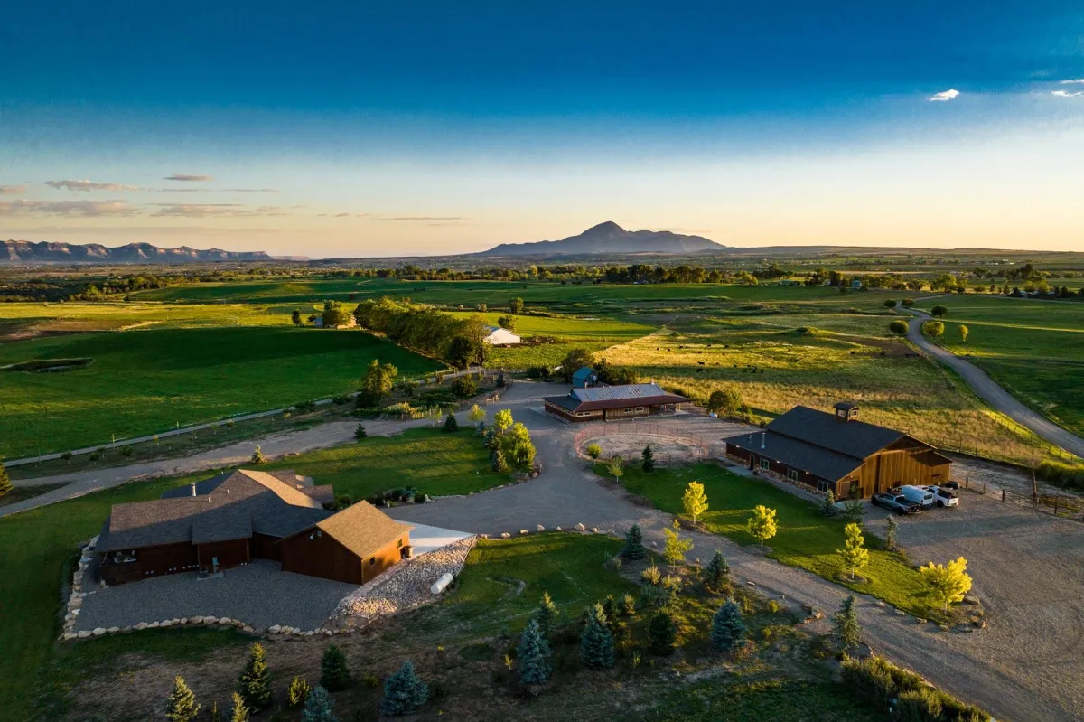 Large ranch property at sunset with view of Sleeping Ute Mountain