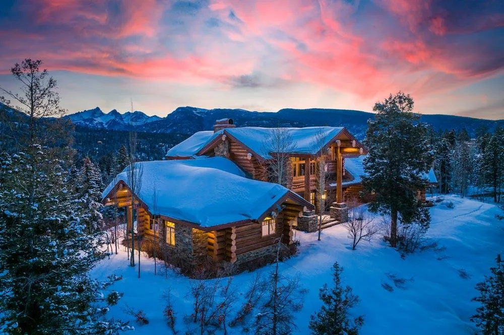 Log home in winter during sunrise