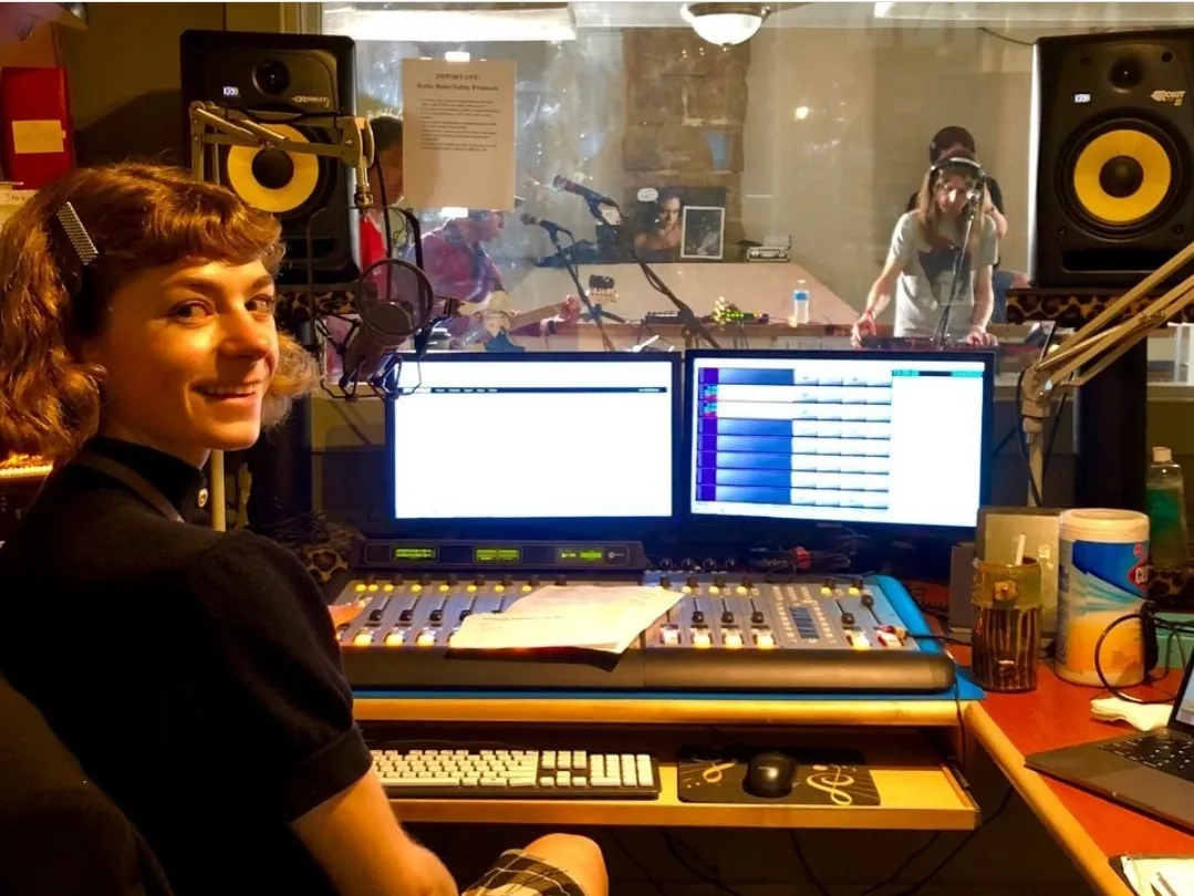 radio boise staff member smiling in a recording booth