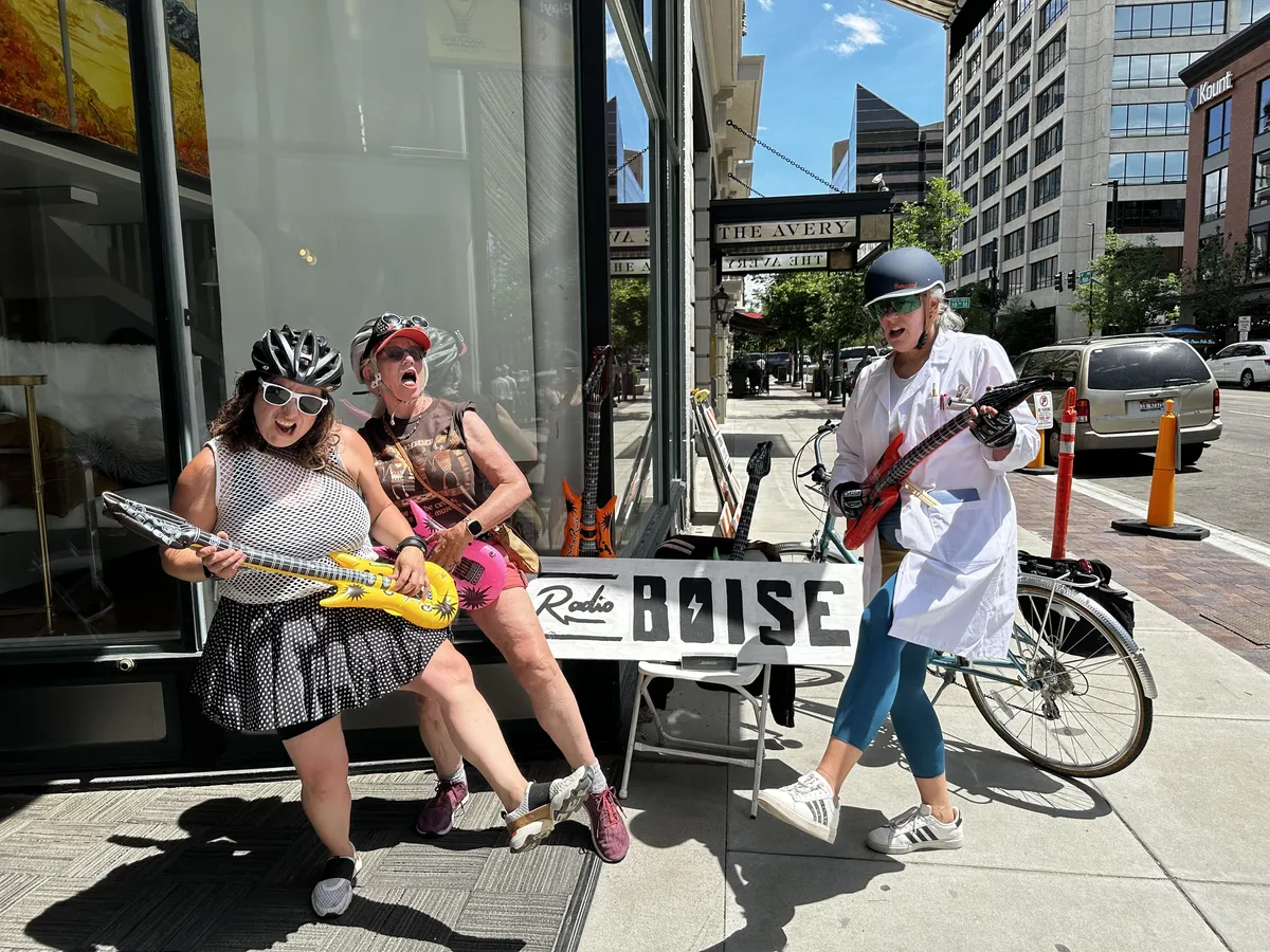 radio boise team members standing outside fake playing guitars