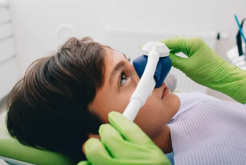 a dental room with a chair and a monitor