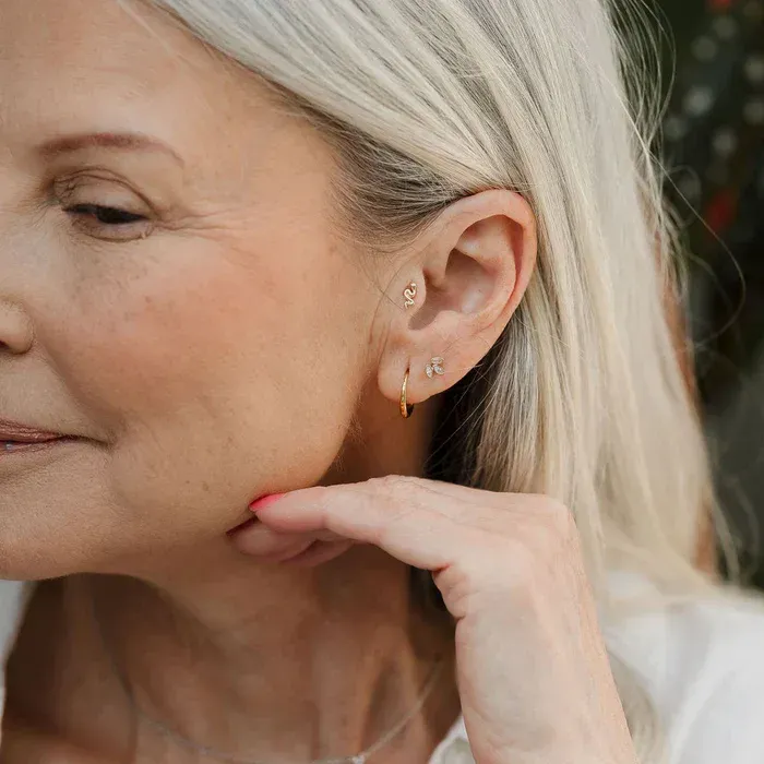 Woman with cigarette under red and blue lights.