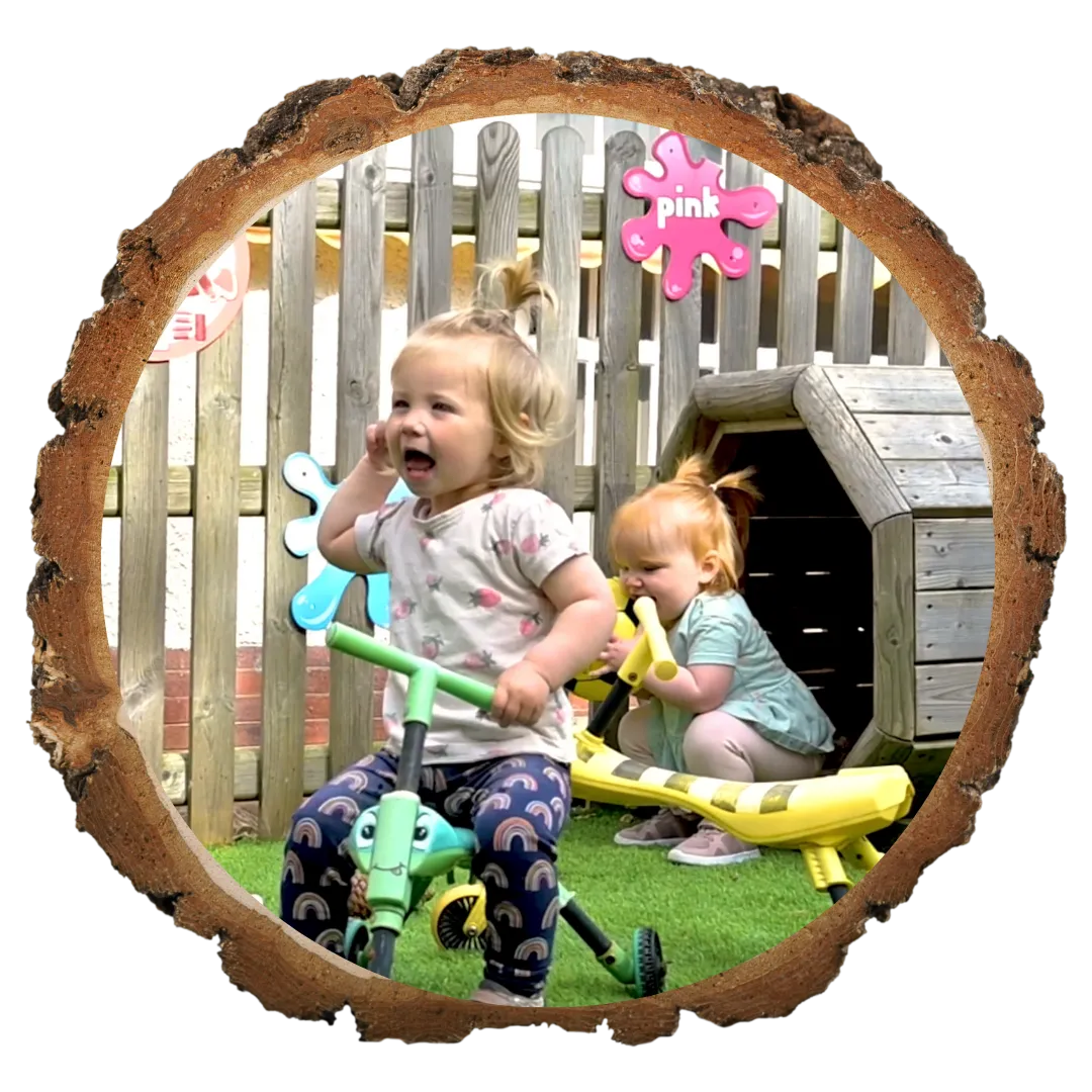 infant girl playing on bike