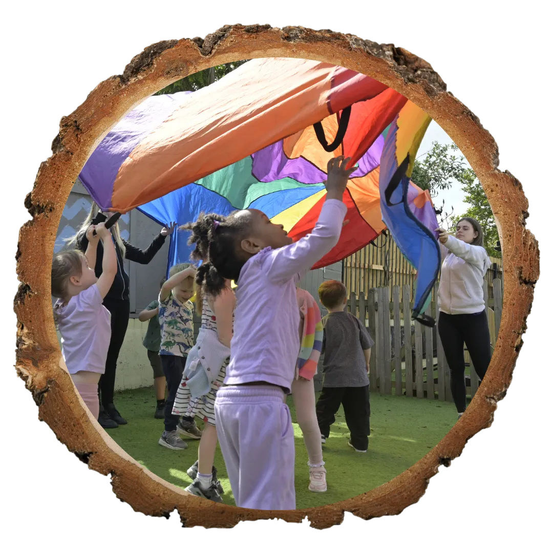 infants playing with parachute