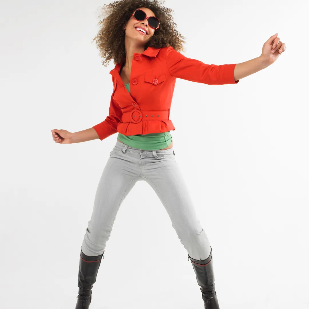 Image of happy slim woman dancing wearing skinny jeans