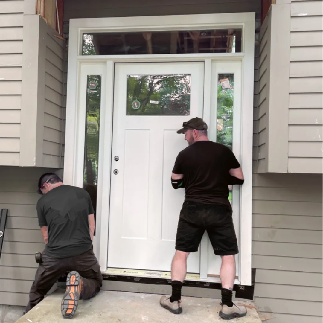 Professional door installers adding a new entry door to home in Austin Texas