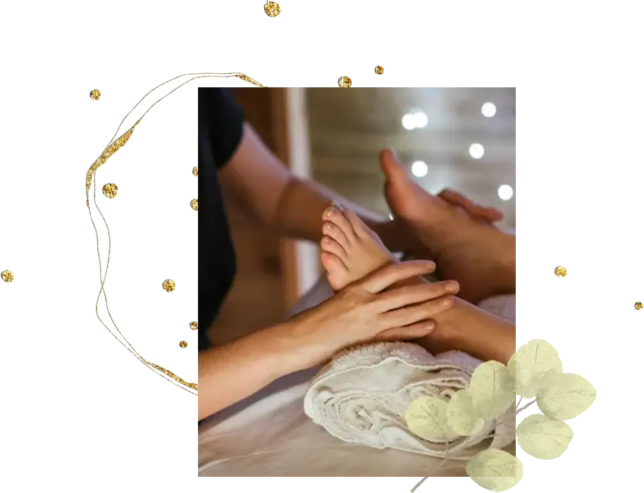 Close-up of a person receiving a foot massage, with hands gently massaging the foot. The setting is dimly lit, enhanced by the soothing scent of massage essence and highlighted with a soft focus background and small, decorative lights.