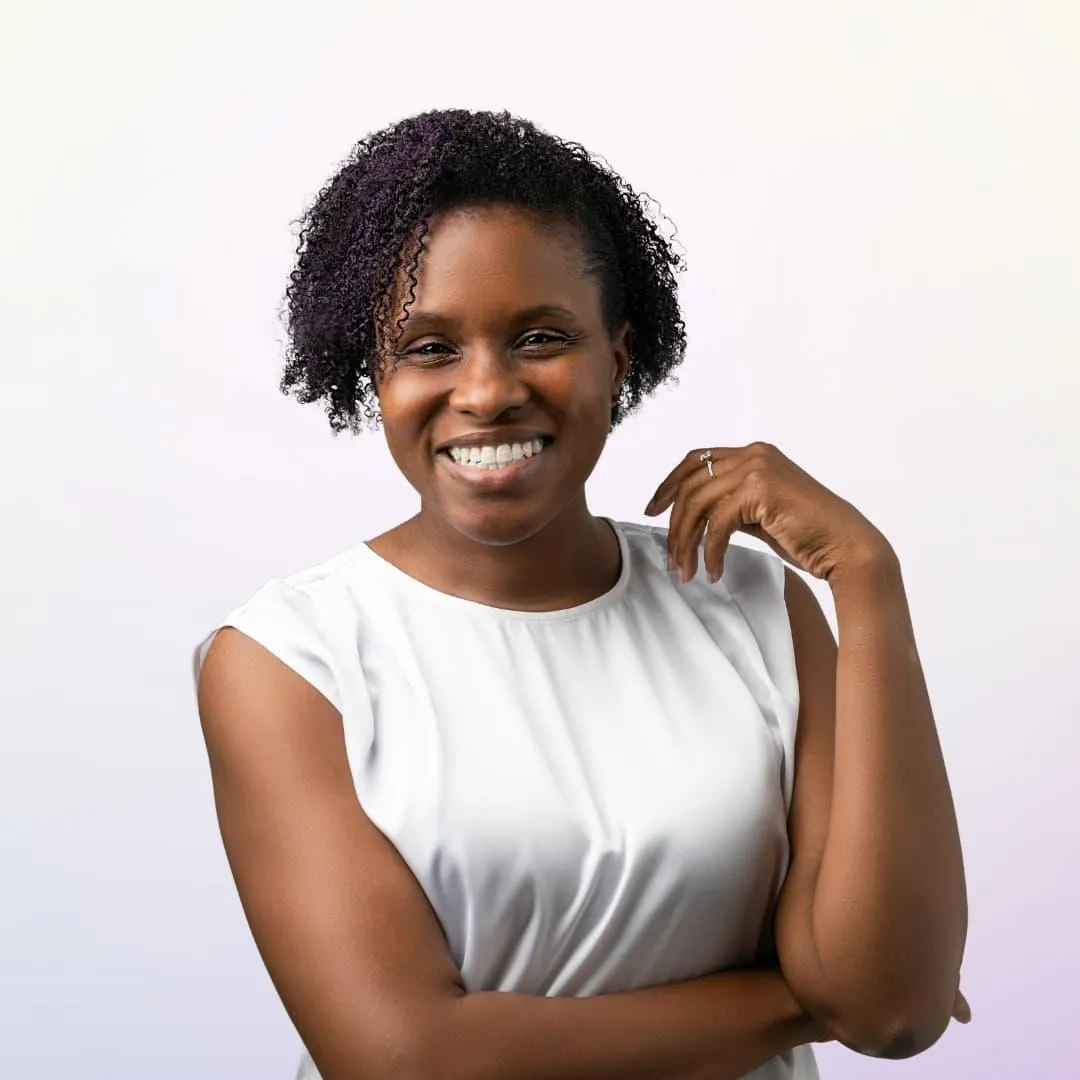 Merissa Si-Lence smiling in a bright, minimalist setting—representing empowerment, focus, and digital entrepreneurship