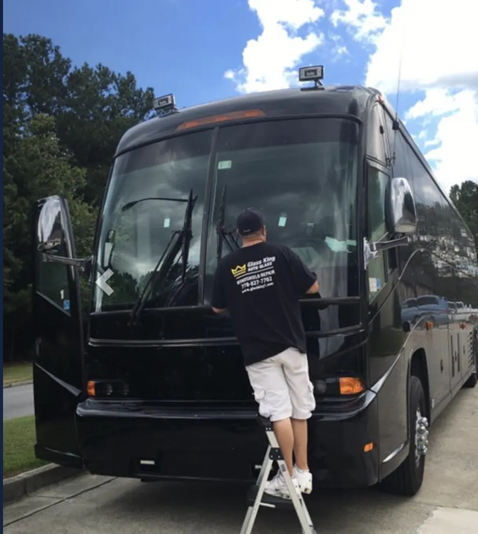 Technician repairing power window regulator inside car door