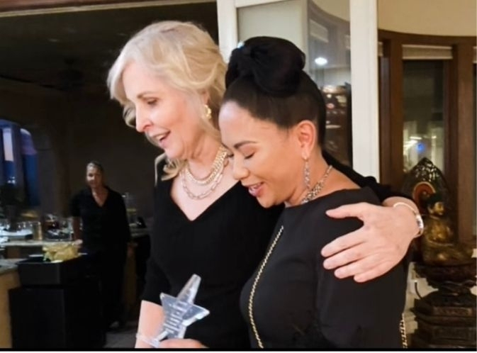 Dr. Pamela Donnelly offers a hug of appreciation to Bernadine Murphy