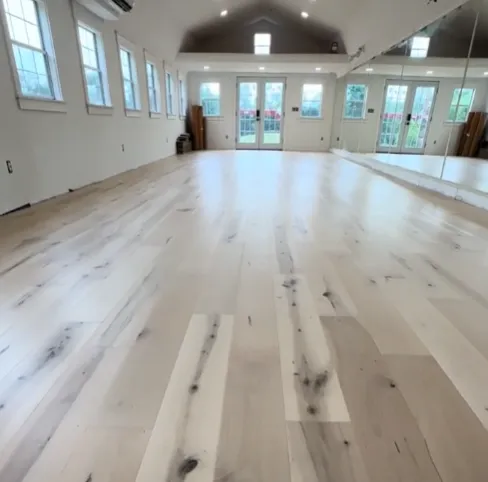 a pile of wood behind a metal fence