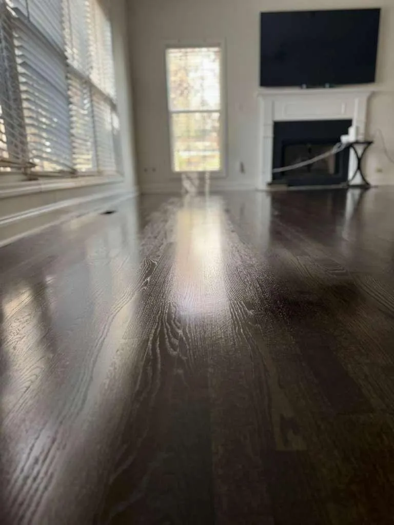 a pile of wood behind a metal fence