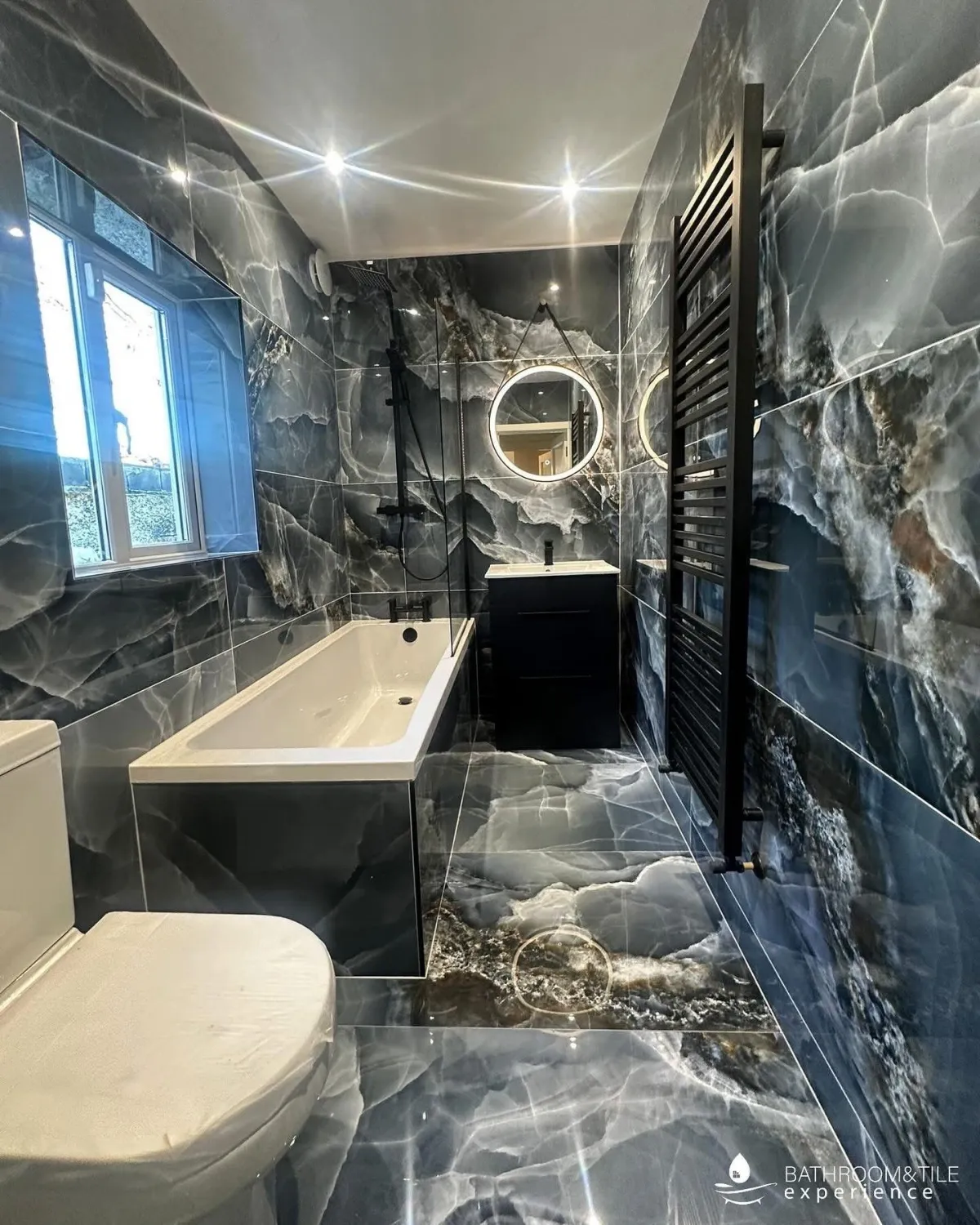 white ceramic bathtub beside white wall