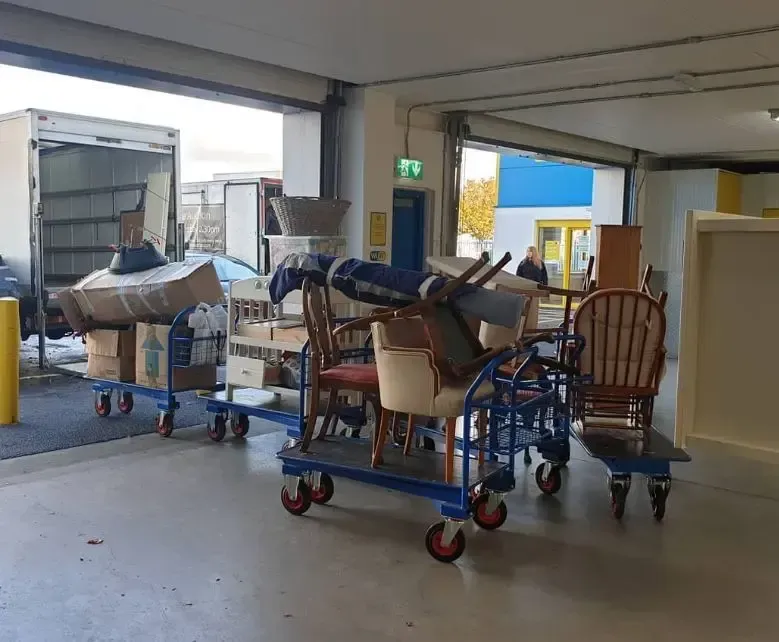 Quick Fix Removals team loading furniture onto trolleys for office move