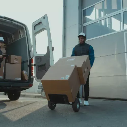 Mover wheeling boxes on a trolley into a van for an office removal in Dublin