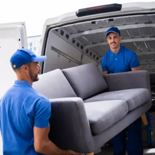 Fully insured Quick Fix Removals movers carefully loading furniture into a van