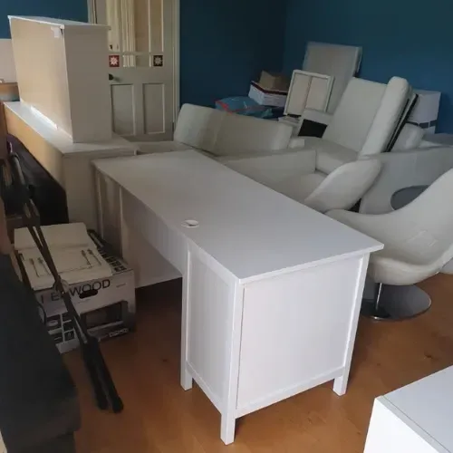 Professional business removal team loading office furniture and equipment into a removal van