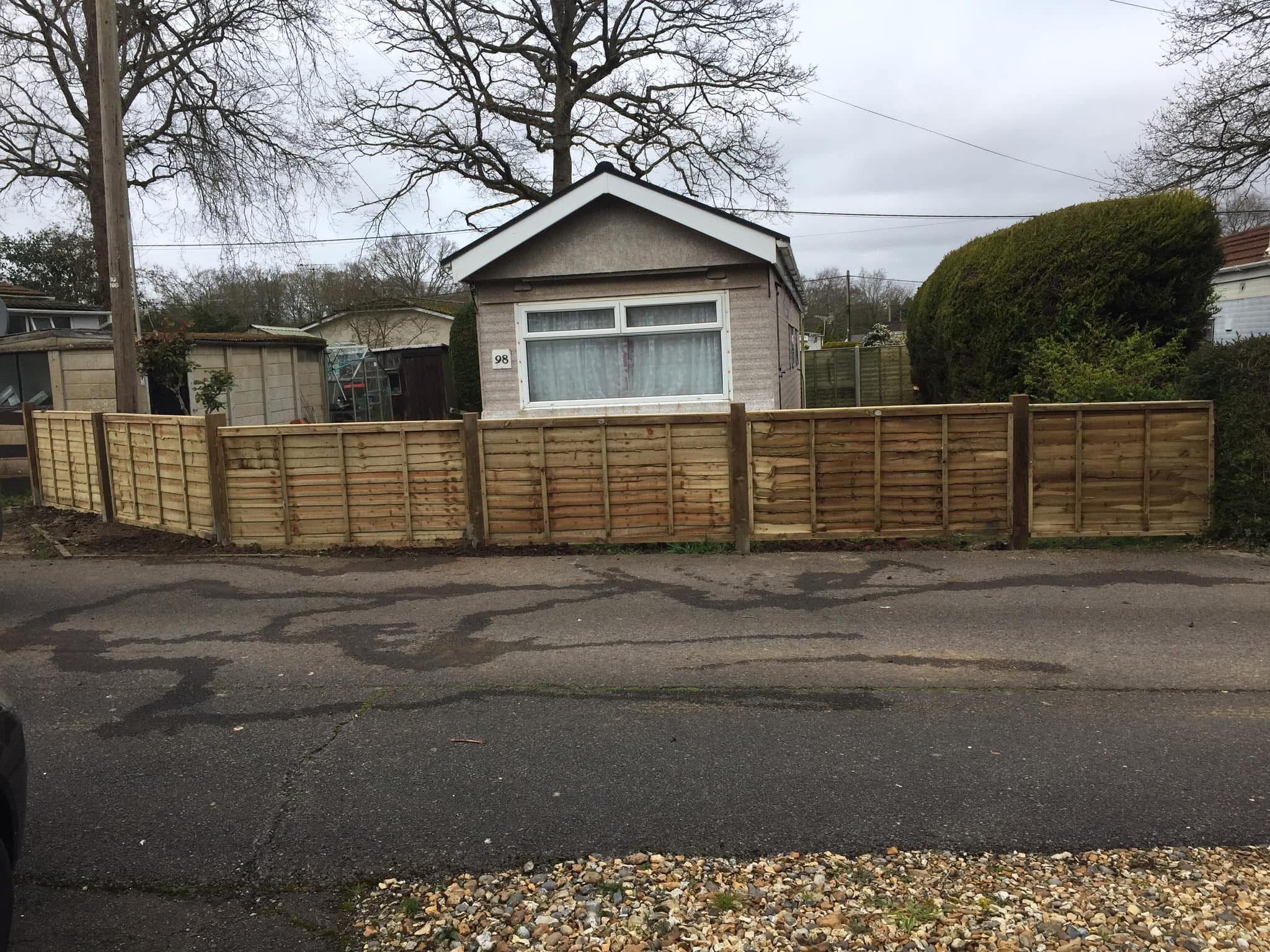 Fence cleaning in Wimborne washing green algae off a timber garden fence