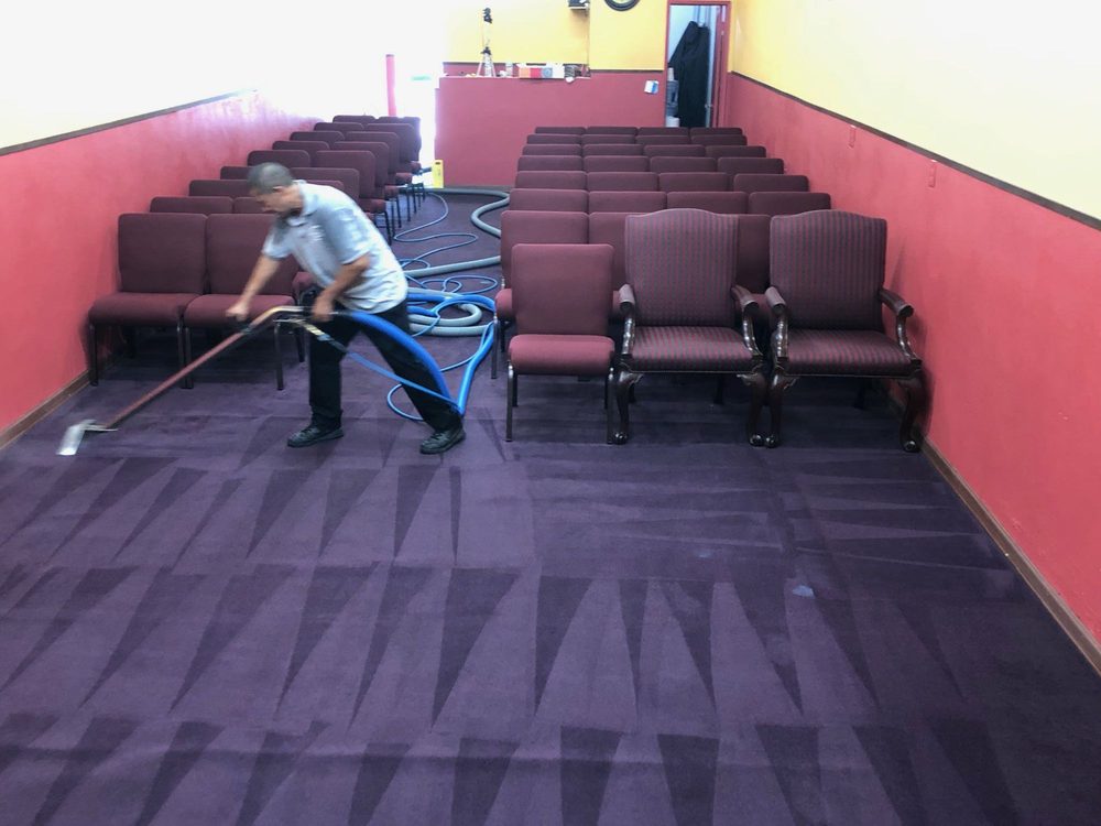 Technician performing professional carpet steam cleaning in a Los Angeles home