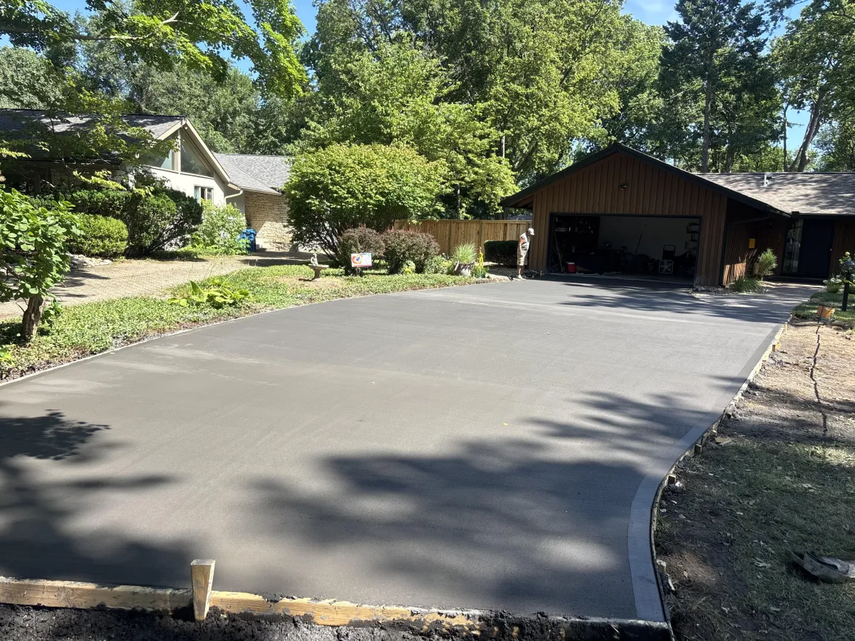 New concrete driveway installation in Kansas City residential neighborhood with clean edges and broom finish