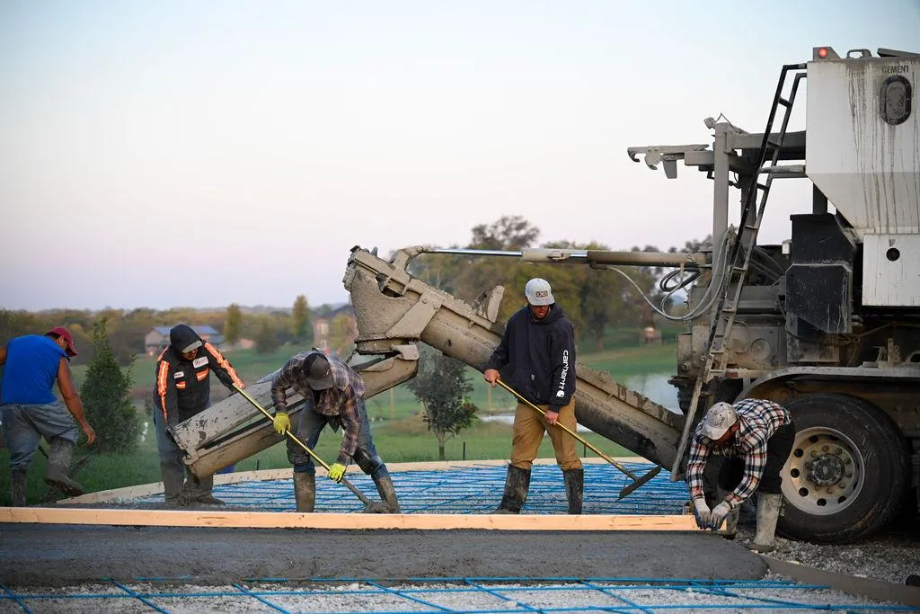 New concrete driveway installation in Kansas City residential neighborhood with clean edges and broom finish