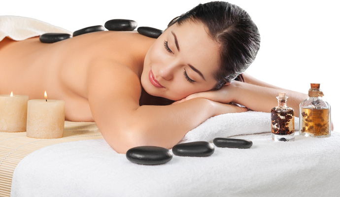 Hot stone massage Bellevue - heated basalt stones placed along client's spine for deep muscle relief
