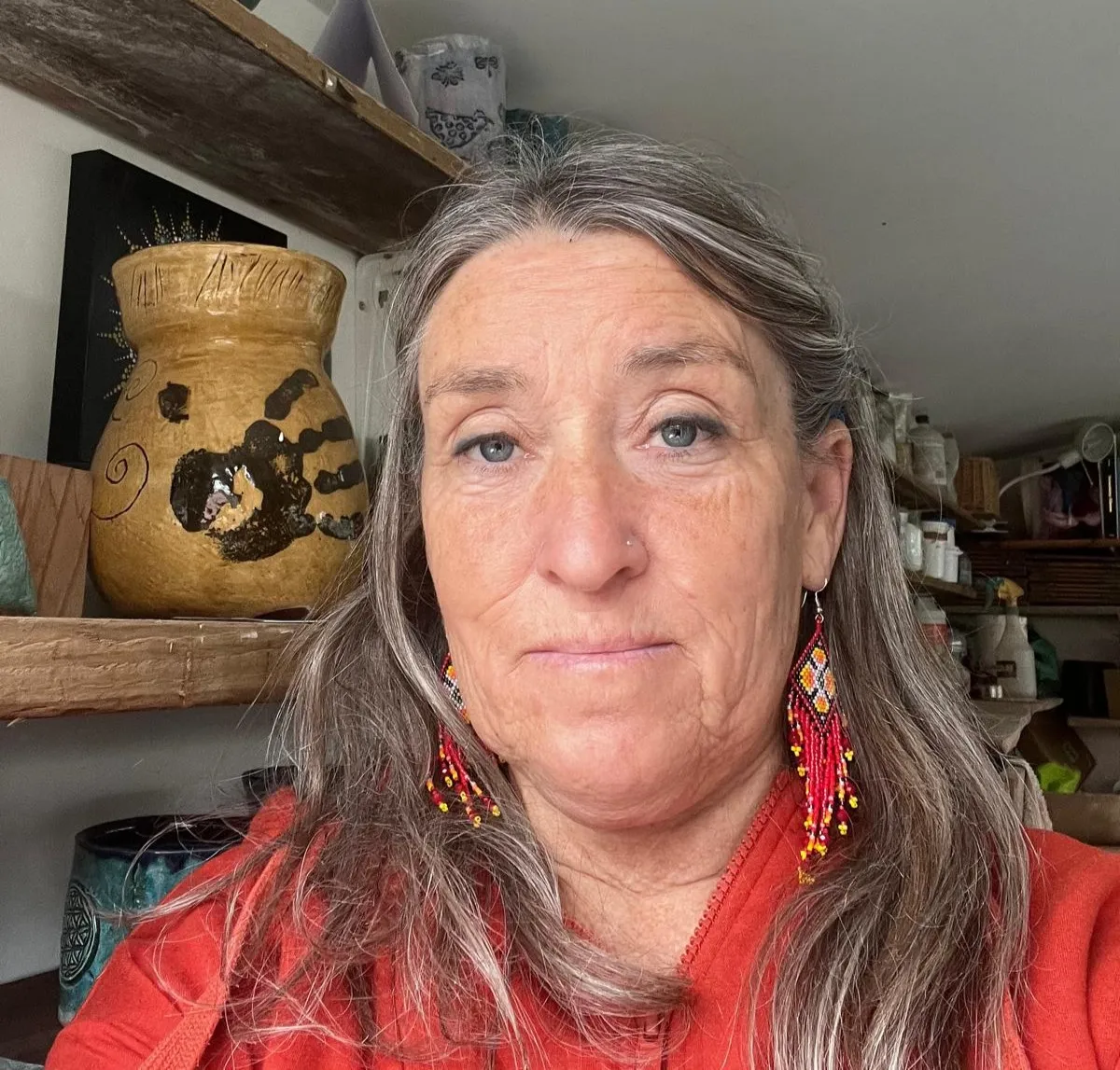 Portrait photo of a woman with long grey hair.