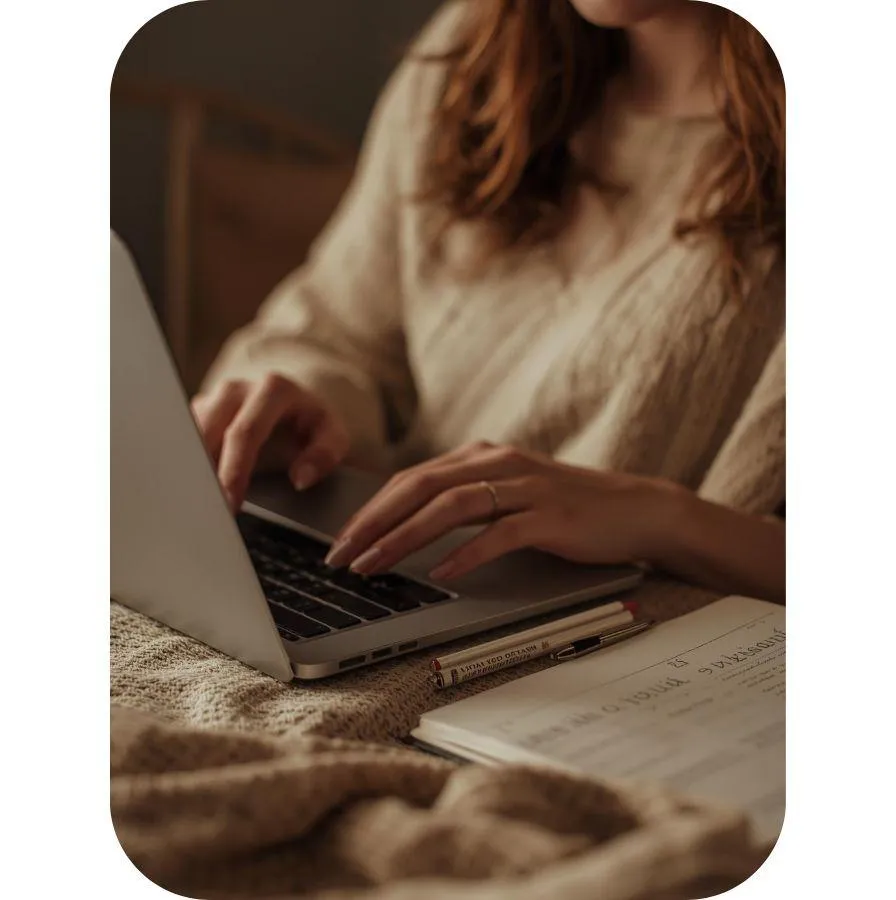 Woman typing at her laptop