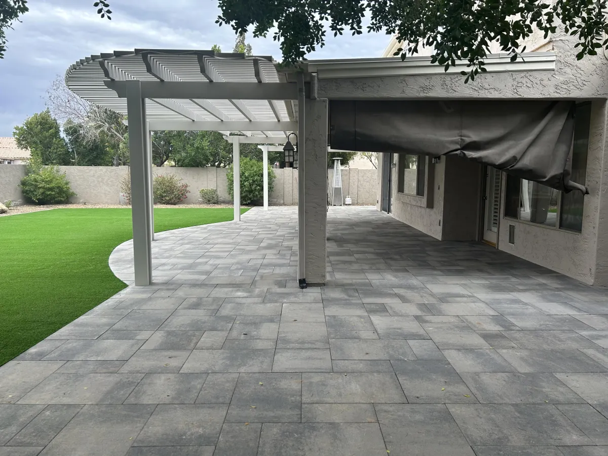 Custom-designed pergola over a paver patio, providing shade and enhancing the outdoor living space with style and functionality.