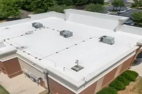 Completed flat roof replacement on brick commercial building by Maple Grove Commercial Roofing Co