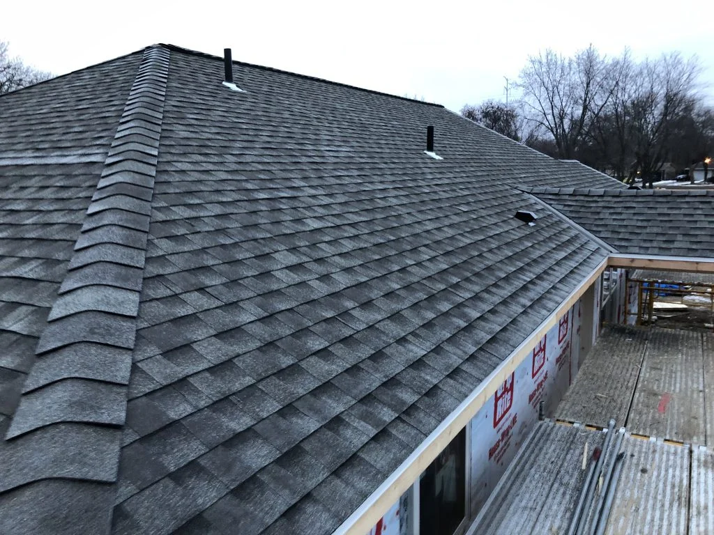 The roof of a building with a tree in the background