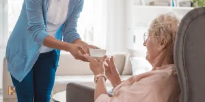 Old person being taken care by a  nurse, Long term care insurance