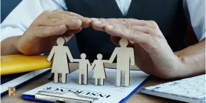 A Hand covering a family group, dipcting the life insurance coverage