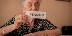 Old person holding a card with text pension, showing Annuity income for life.