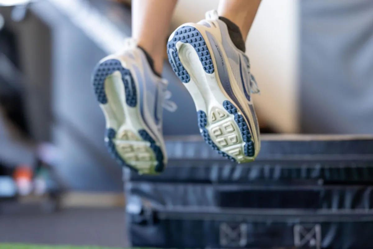 Gym photo of someone jumping on a box