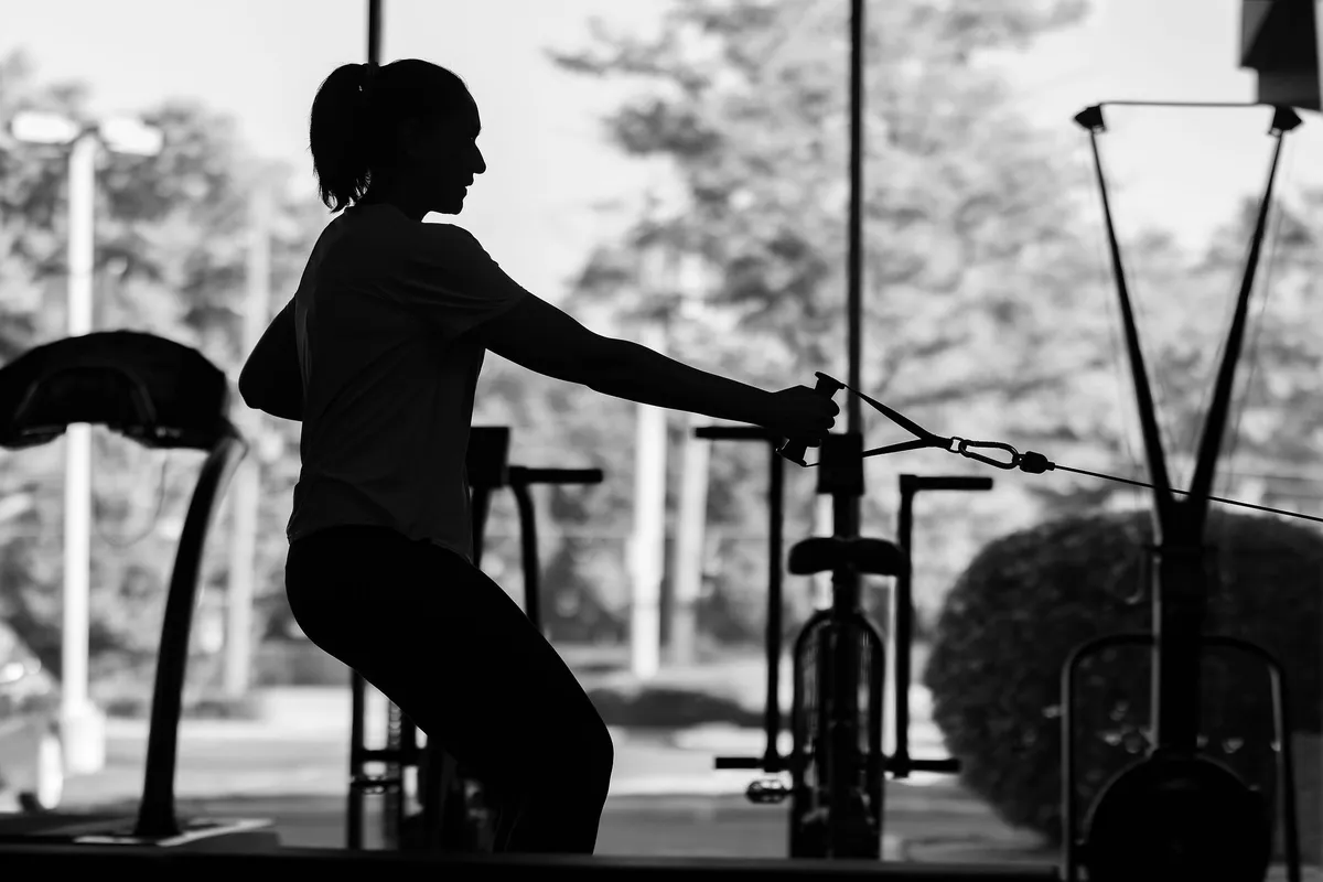 Woman using cable machine in the gym 