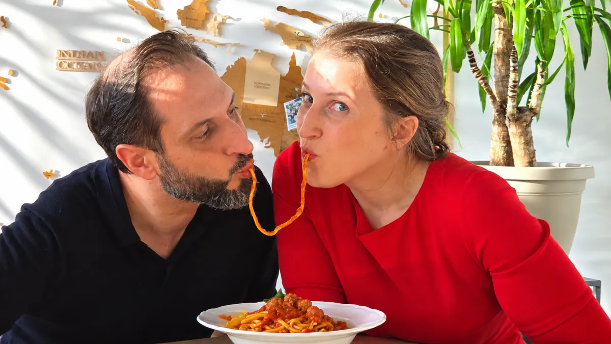 Vallì and Dave eating a dish of homemade pasta like Lady and the Trump scene