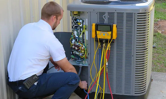 Routine air conditioning maintenance on outdoor AC unit in Bogalusa